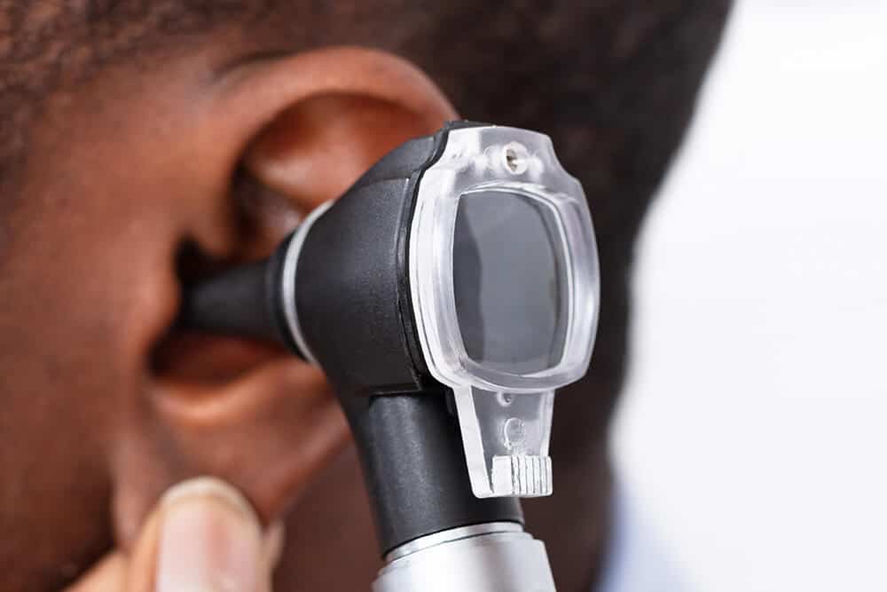 Doctor issuing ear exam